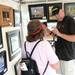 Ann Arbor artist Steve Davis chats with a family friend while in his booth during the State St. Art Fair on Wednesday, July 17, 2013. Melanie Maxwell | AnnArbor.com